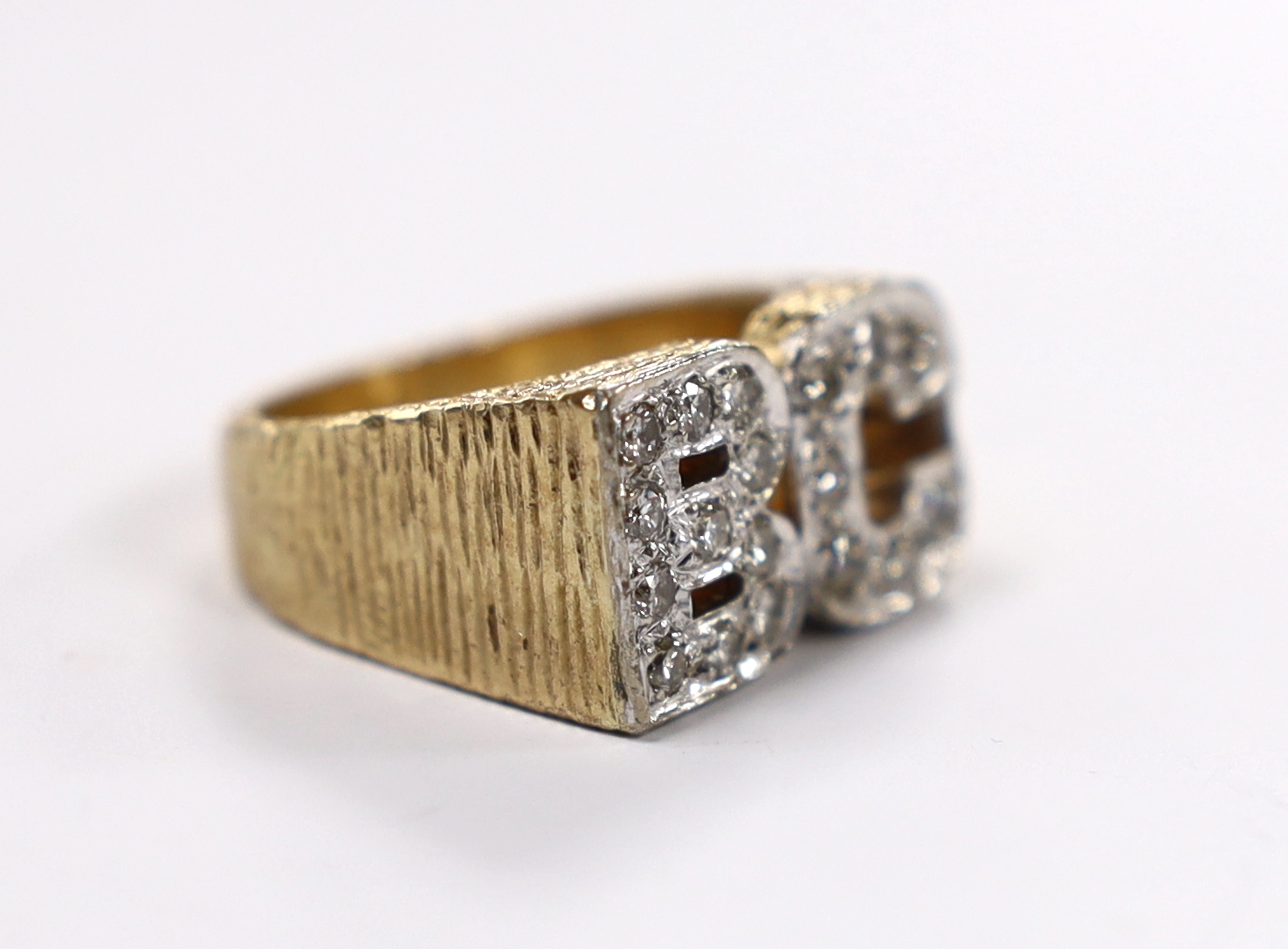 A textured 9ct and diamond cluster set 'BC' initials ring, size Q, gross weight 14.3 grams.